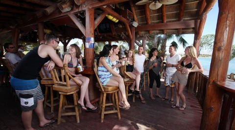 Group of people relaxing at outdoor ocean bar